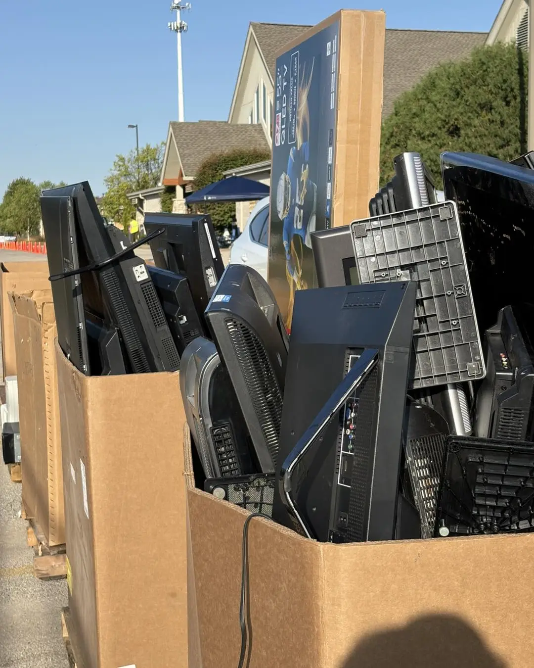 Boxes filled with old televisions and electronics for recycling