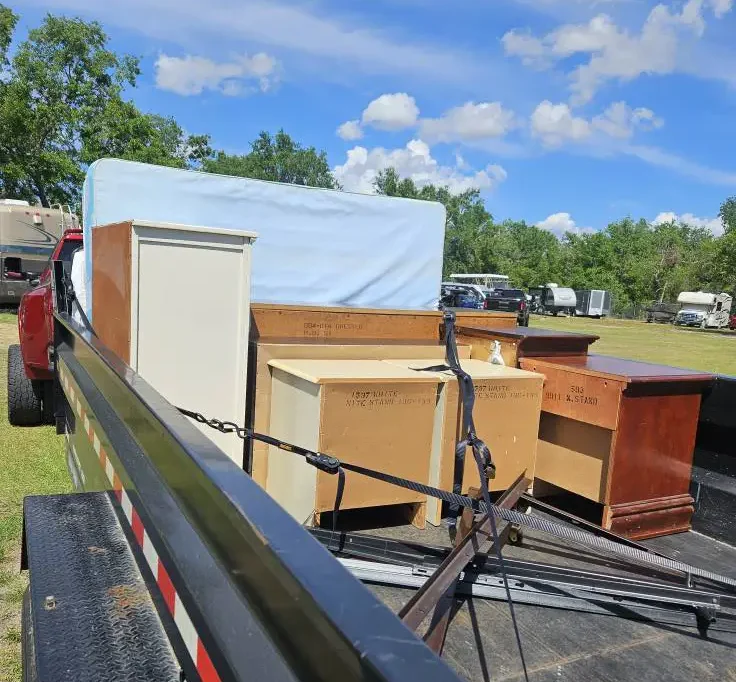 Truck loaded with old furniture and dressers for junk removal