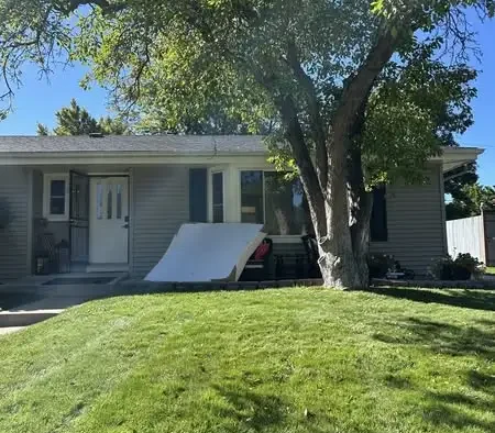 Old mattress placed outside a suburban home ready for pickup and disposal