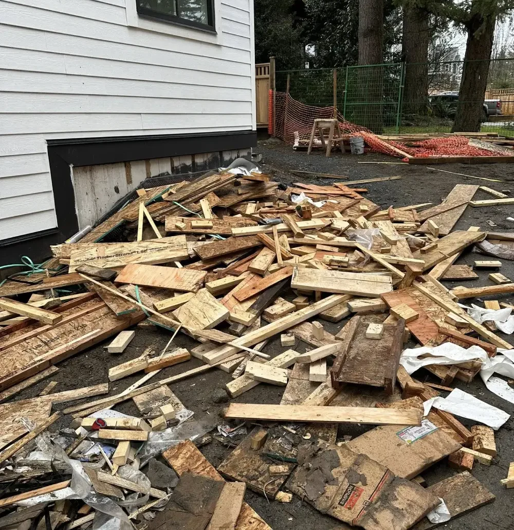 Pile of construction wood debris outside a residential building