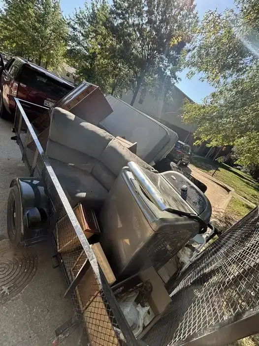 Truck trailer loaded with old furniture and appliances for junk removal