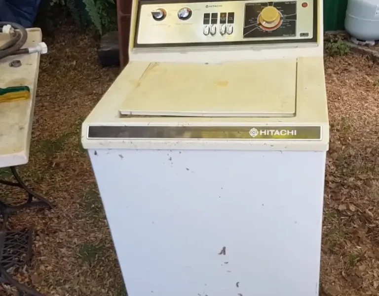 Old Hitachi top-load washing machine sitting outdoors on a residential property in Asheville NC ready for appliance removal and recycling